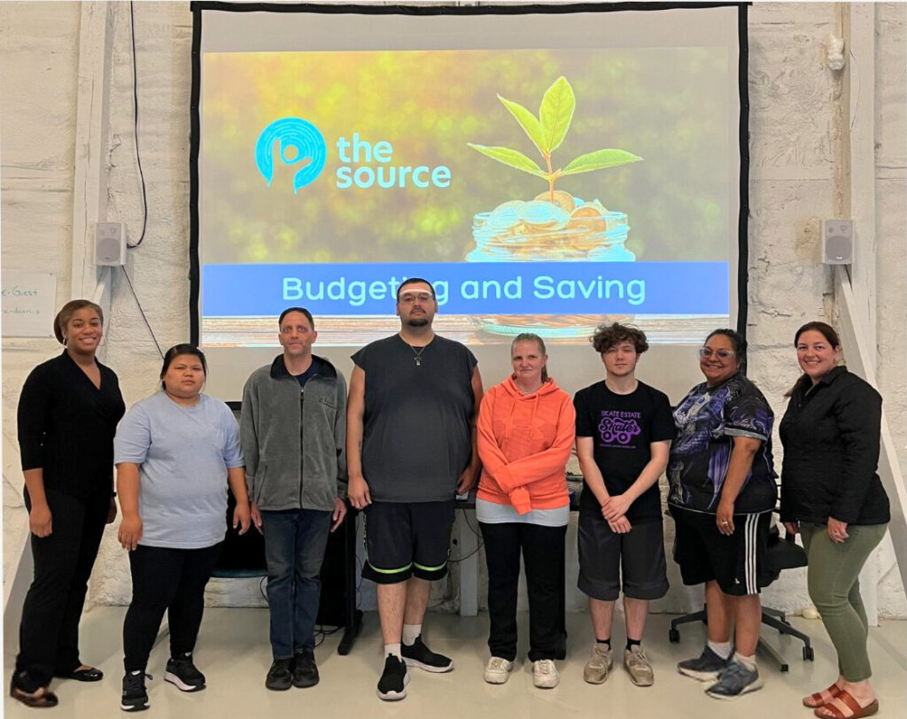 Group photo of employees of The SOURCE member companies at a financial literacy class.