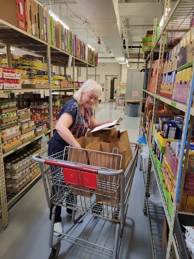 Volunteer packs donated food at the Clinton Township Food Pantry
